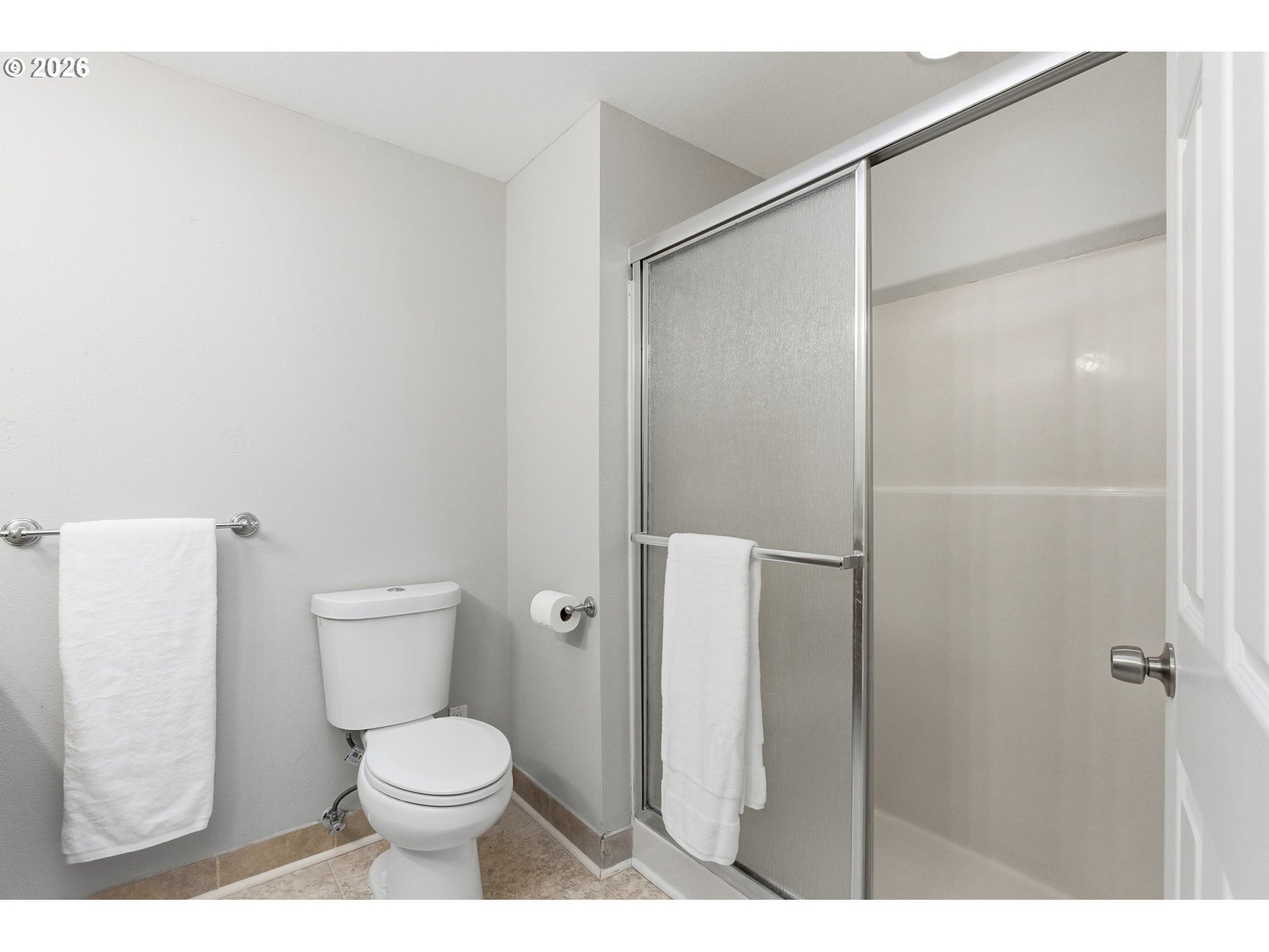 5585 Northwest Peregrine Place Portland, OR 97229 - Photo 33 of 47 a white toilet sitting next to a bathroom sink