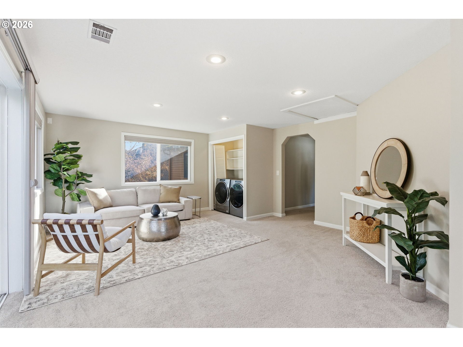 5585 Northwest Peregrine Place Portland, OR 97229 - Photo 38 of 47 a living room with furniture a window and potted plants