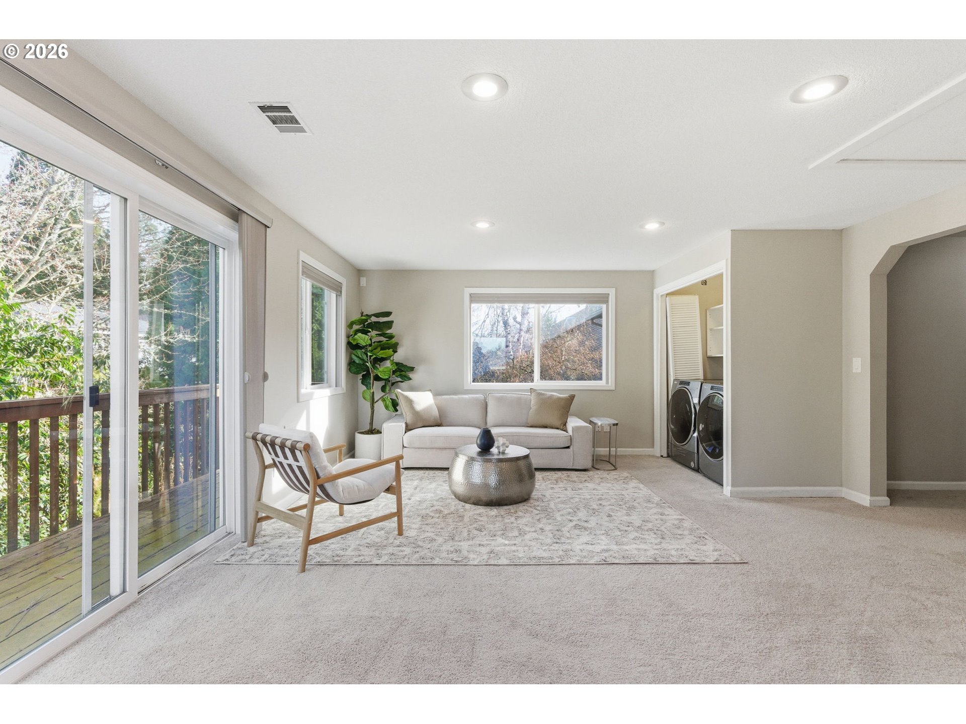 5585 Northwest Peregrine Place Portland, OR 97229 - Photo 42 of 47 a living room with furniture a large window and potted plants