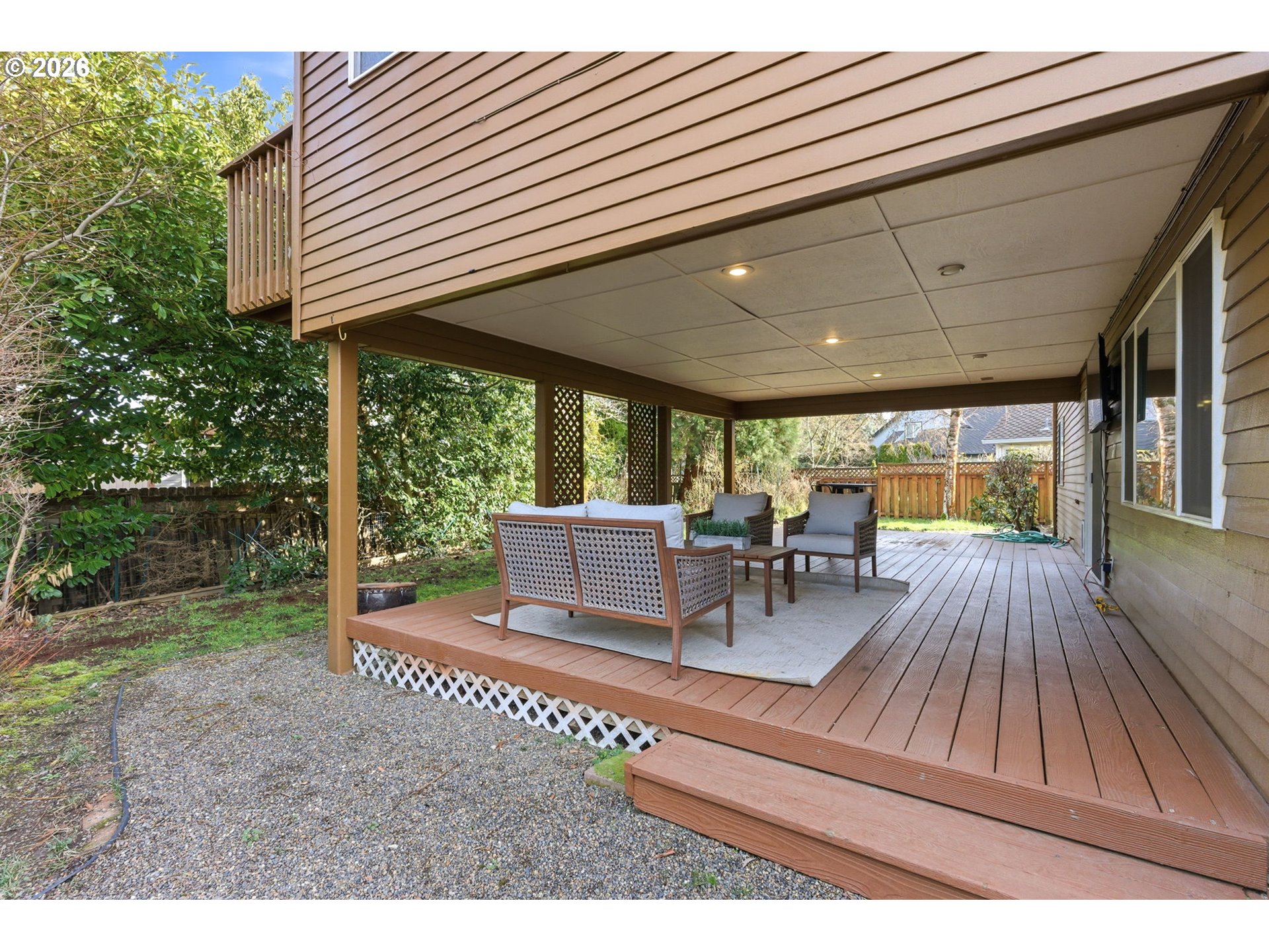 5585 Northwest Peregrine Place Portland, OR 97229 - Photo 44 of 47 a view of a patio with table and chairs with wooden floor and fence