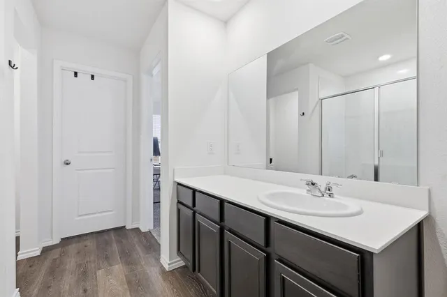 a bathroom with a sink double vanity and a mirror