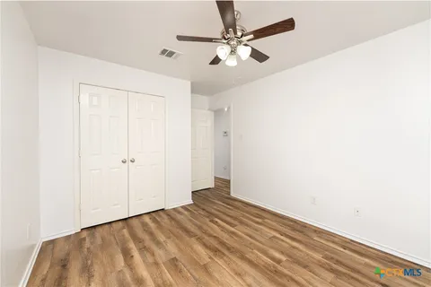a view of a room with wooden floor