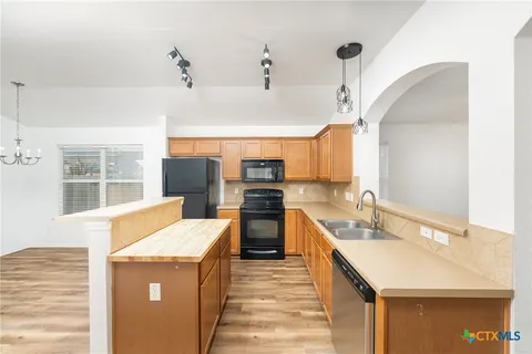 a kitchen with a stove and a sink