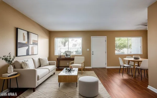 a living room with furniture and wooden floor