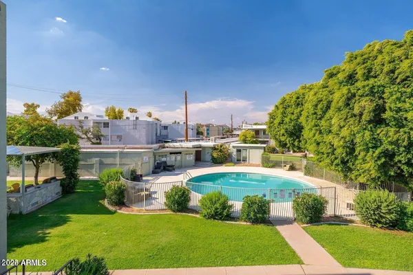 a backyard of a house with table and chairs