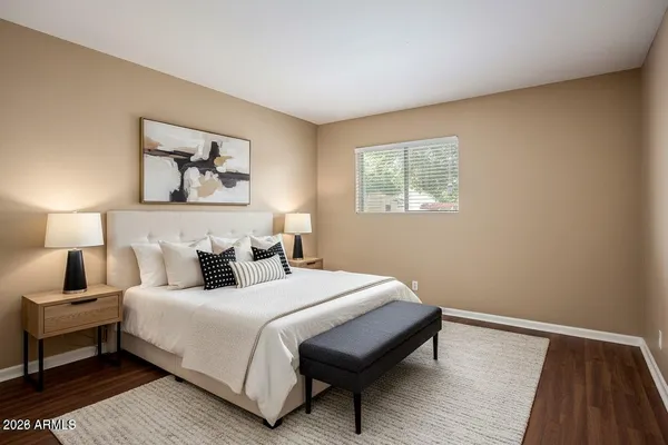 a bedroom with a bed and a night stand