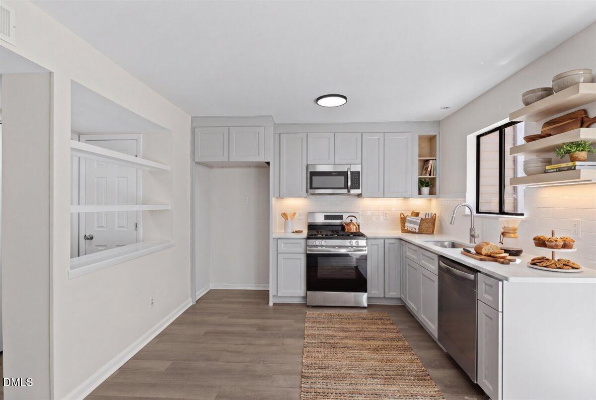 5806 Shady Grove Circle Raleigh, NC 27609 - Photo 11 of 28 a kitchen with cabinets and stainless steel appliances
