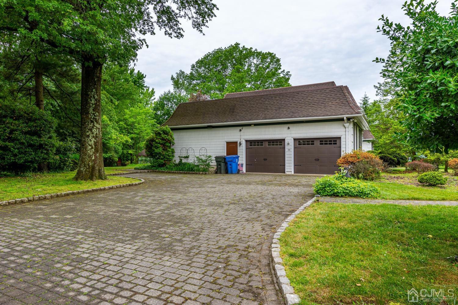 355 New Dover Road Colonia, NJ 07067 - Photo 44 of 45 a front view of a house with a yard and trees