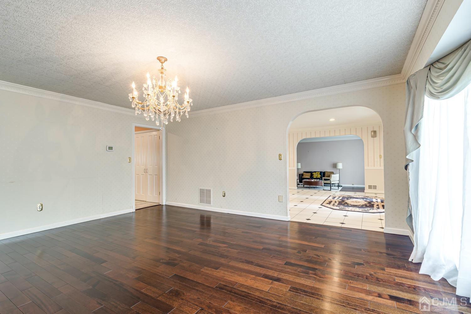 355 New Dover Road Colonia, NJ 07067 - Photo 7 of 45 a view of a room with wooden floor and chandelier