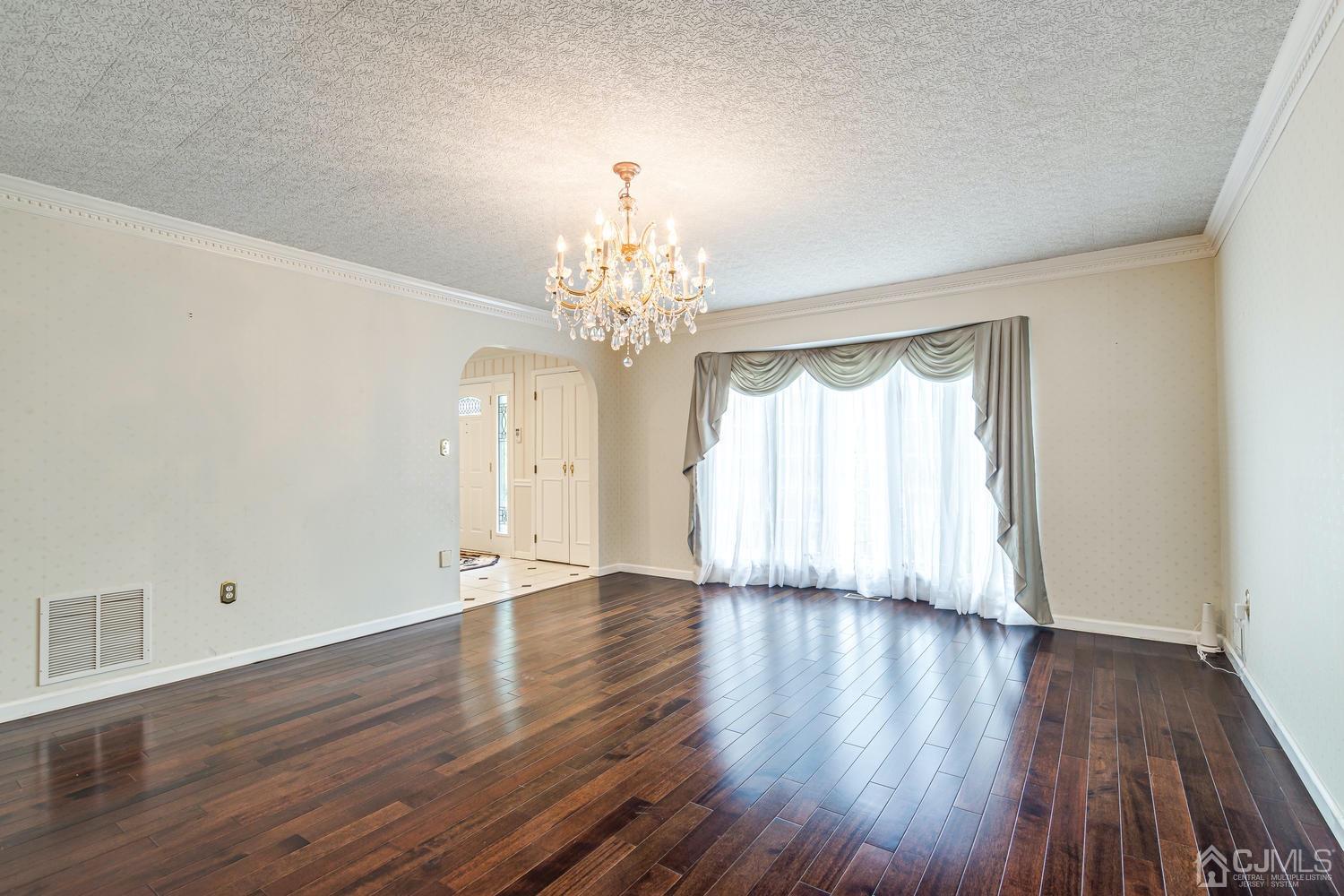 355 New Dover Road Colonia, NJ 07067 - Photo 8 of 45 a view of an empty room with wooden floor and a window