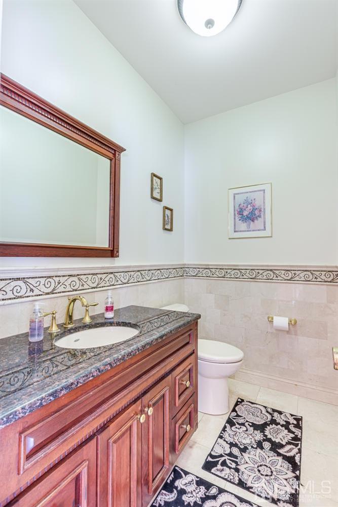 355 New Dover Road Colonia, NJ 07067 - Photo 9 of 45 a bathroom with a granite countertop sink mirror vanity and toilet