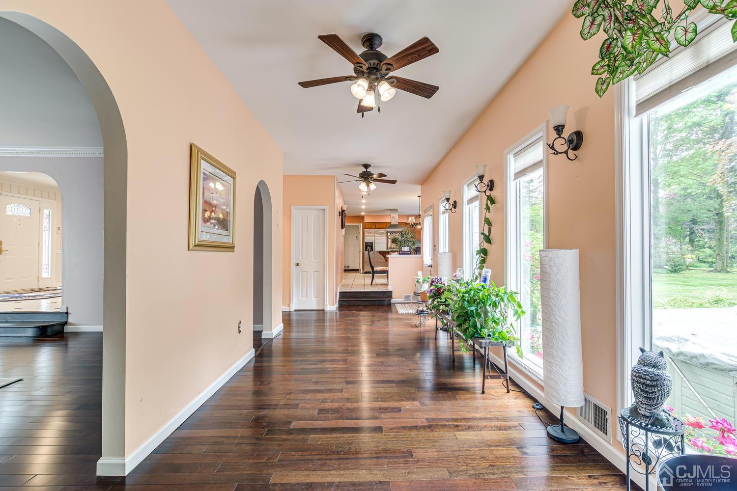 355 New Dover Road Colonia, NJ 07067 - Photo 10 of 45 a view of an entryway with wooden floor and a chandelier