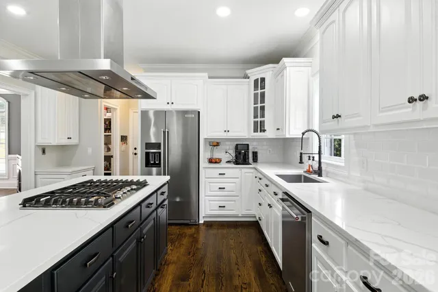 a kitchen with stainless steel appliances a sink stove and refrigerator