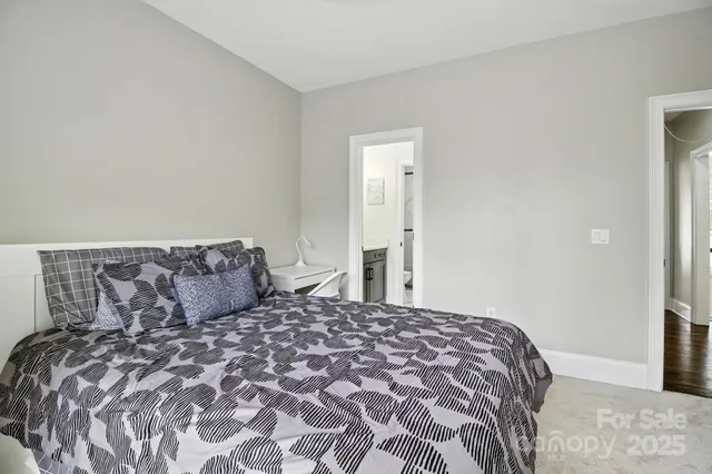 a large bed sitting in a bedroom next to a bathroom