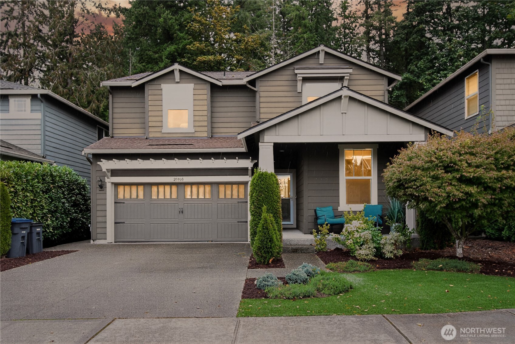 25900 243rd Avenue Southeast Maple Valley, WA 98038 - Photo 1 of 23 a front view of a house with a yard and garage