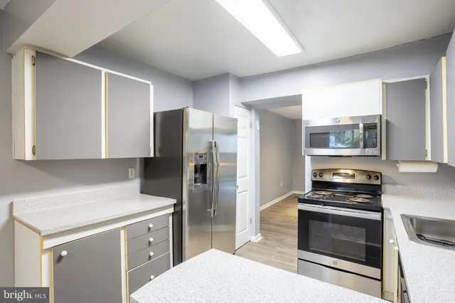 a kitchen with a refrigerator stove and microwave