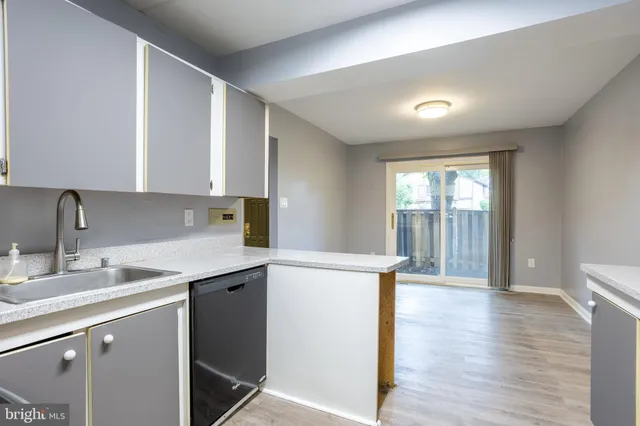 a kitchen with a sink a window and appliances