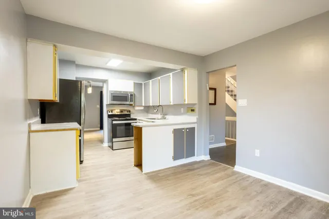 a kitchen with granite countertop cabinets and stainless steel appliances