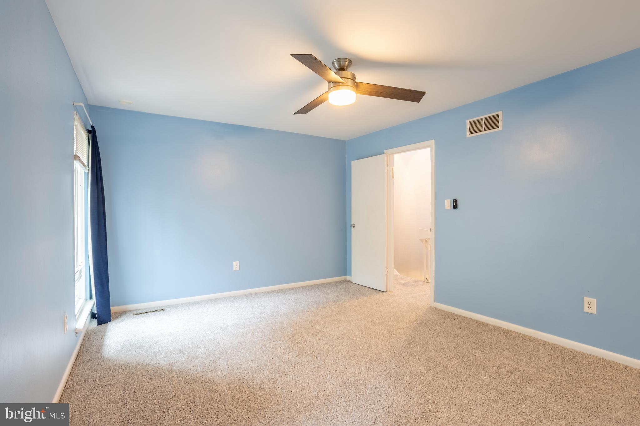 2835 Baneberry Court Baltimore, MD 21209 - Photo 16 of 42 an empty room with windows and fan