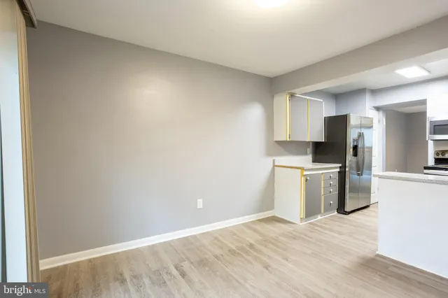 a kitchen with a refrigerator and a stove top oven