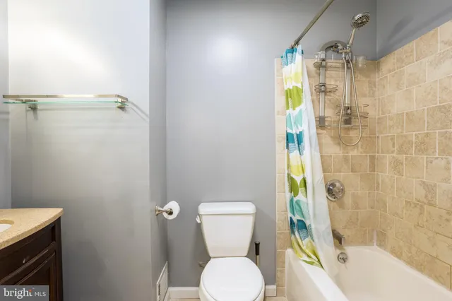 a bathroom with a toilet and shower