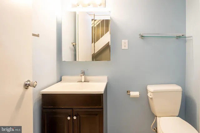 a bathroom with a toilet sink and mirror