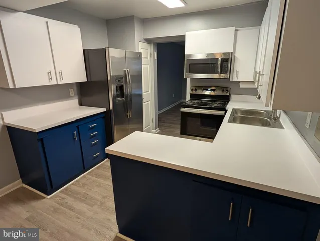 a kitchen with a refrigerator and a sink