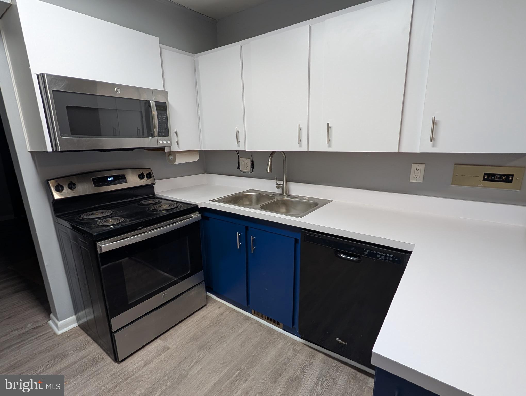2835 Baneberry Court Baltimore, MD 21209 - Photo 9 of 42 a kitchen with a sink stove and microwave