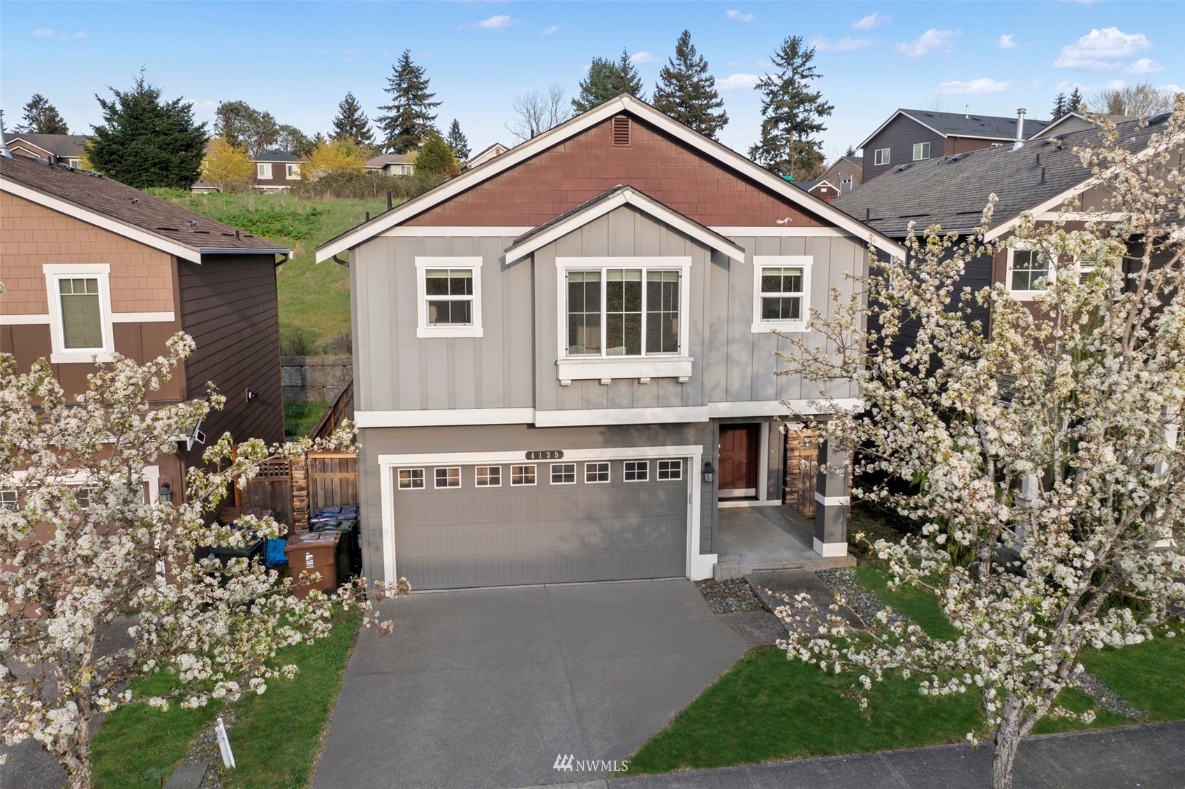 a view of a house with brick walls and a yard with plants