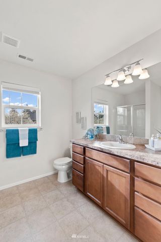 a spacious bathroom with a granite countertop sink and a mirror