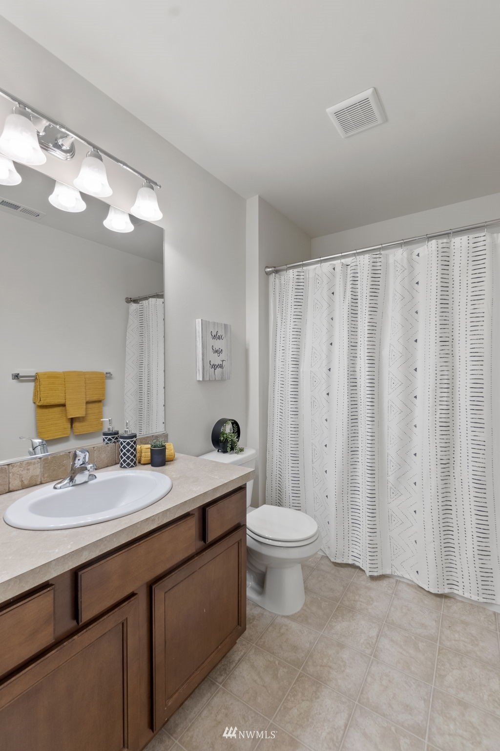 4139 Everett Avenue Tacoma, WA 98404 - Photo 17 of 23 a bathroom with a double vanity sink toilet and a mirror