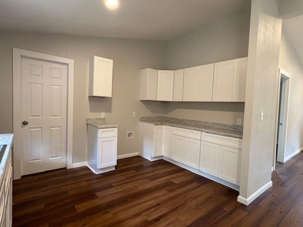 211 VZ County Road 3725 Wills Point, TX 75169 - Photo 6 of 16 a kitchen with granite countertop wooden cabinets and white appliances