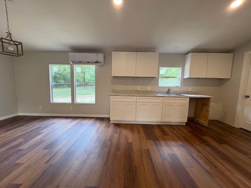 211 VZ County Road 3725 Wills Point, TX 75169 - Photo 7 of 16 a kitchen with wooden floors and white walls