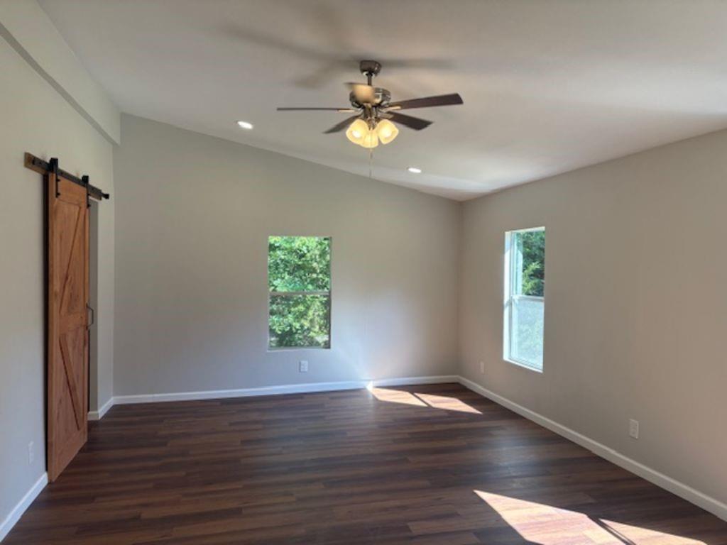 211 VZ County Road 3725 Wills Point, TX 75169 - Photo 8 of 16 wooden floor in an empty room with a window