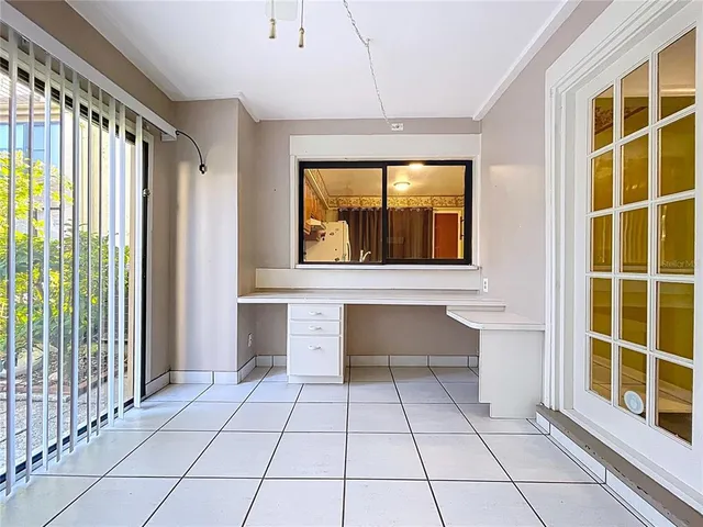 a view of room with window and a chandelier