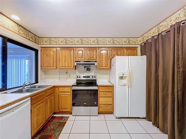 a view of a storage & utility room with a refrigerator
