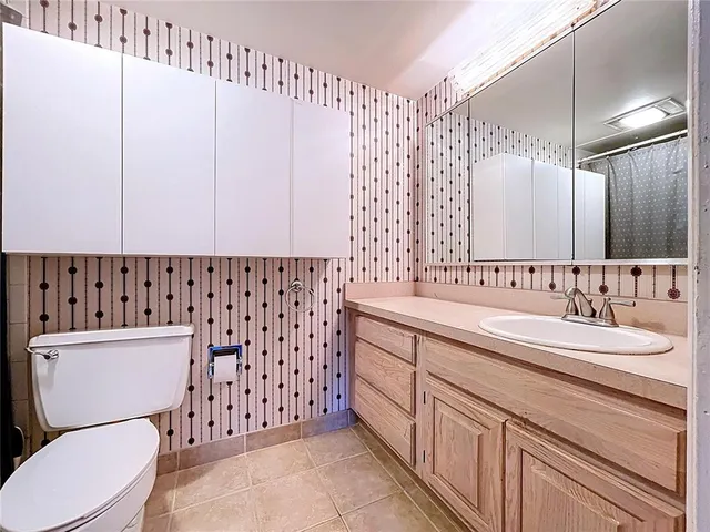 a white toilet sitting next to a bathroom sink and tub
