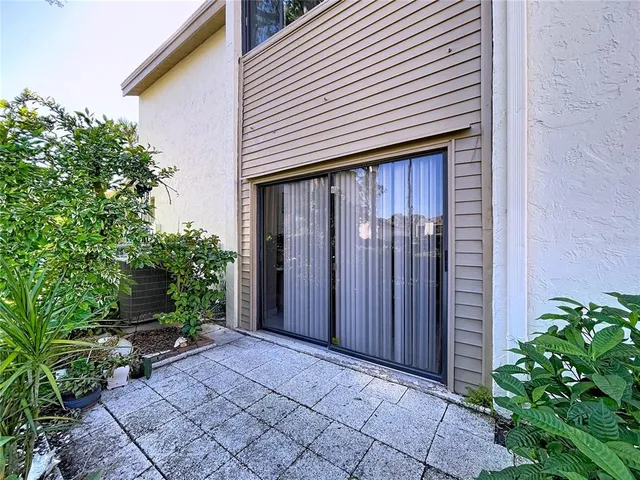 an aerial view of a house with a yard and large trees