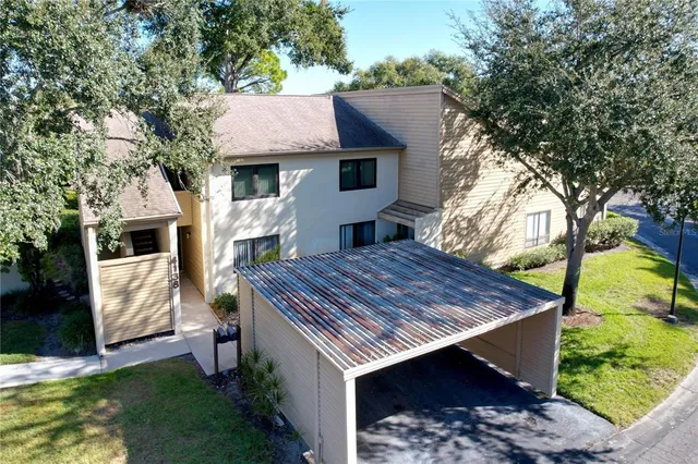 an aerial view of a house with garden space and street view