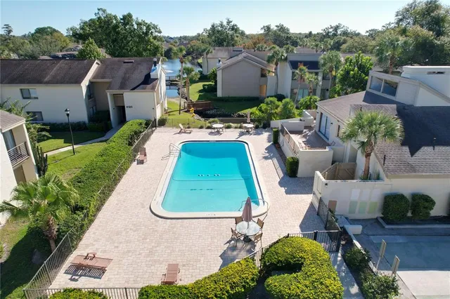 an aerial view of a house with garden space and sitting area