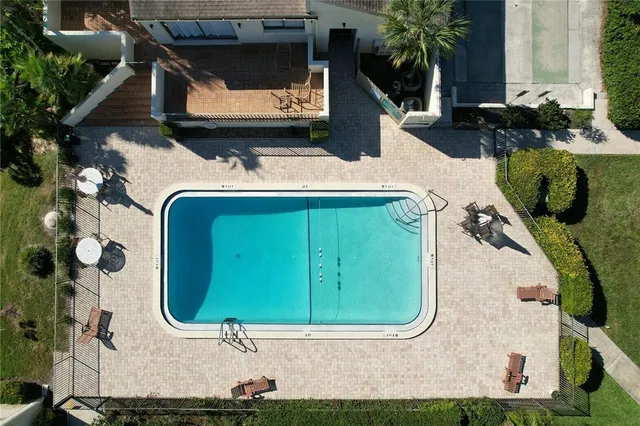 a view of a swimming pool with chairs