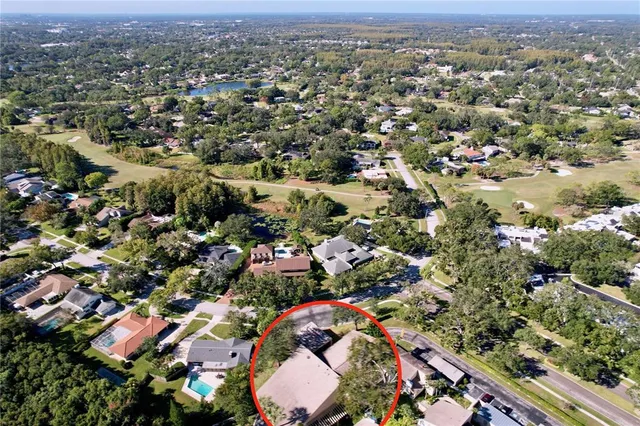 an aerial view of a house with garden space and street view