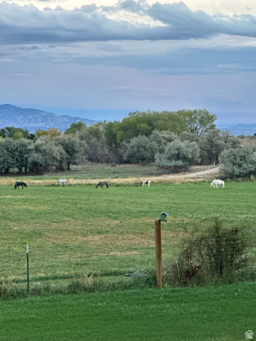 3145 South 500 West Vernal, UT 84078 - Photo 49 of 64 View of grassy yard with a rural view and a mountain view