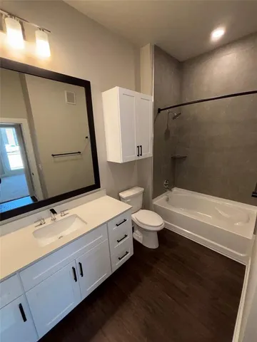 a bathroom with a sink a toilet and bathtub