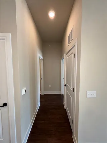 a view of a hallway with a wooden floor