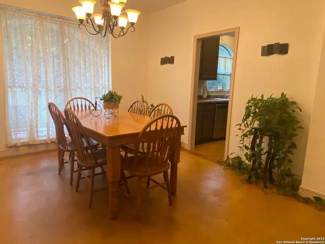 a view of a dining room with furniture and chandelier