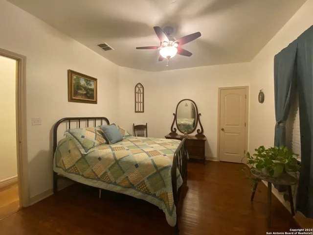 a bedroom with bed and a chandelier