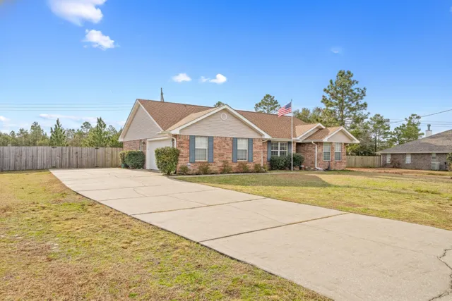 a view of house with outdoor space and swimming pool