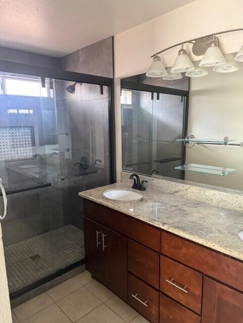 49084 Violet Street Indio, CA 92201 - Photo 4 of 14 a bathroom with a granite countertop sink a mirror and shower