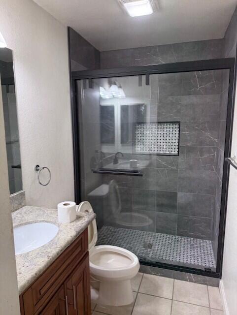 49084 Violet Street Indio, CA 92201 - Photo 5 of 14 a bathroom with a granite countertop sink a toilet a mirror and shower